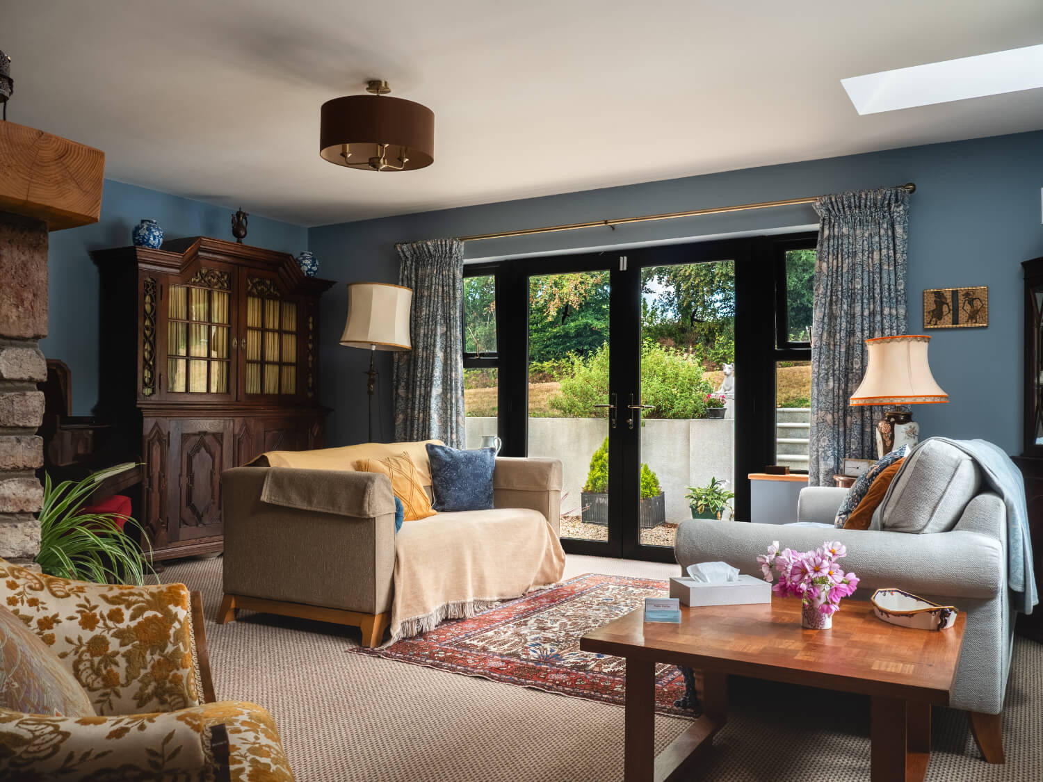 A calm counselling room with comfortable seating and garden views